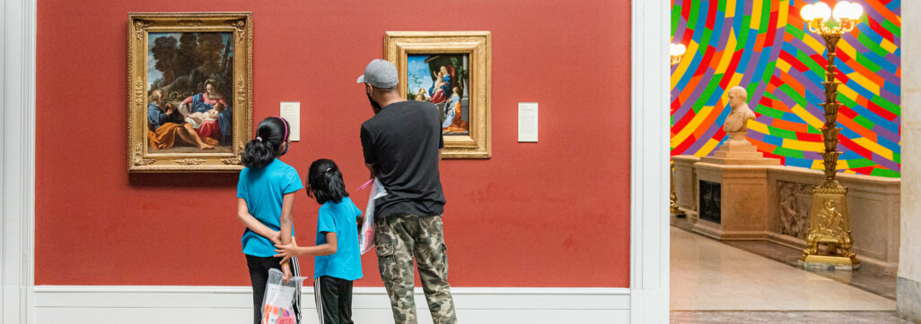 family looking at art in a museum